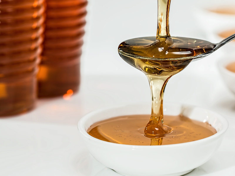 Honey flowing into a spoon