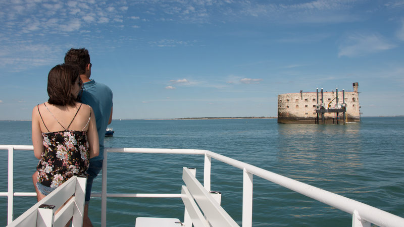 Couple on the deck of a ship, in front of the famous Fort Boyard